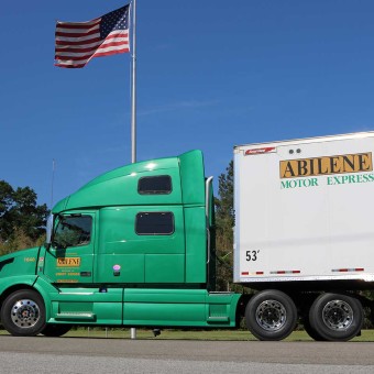 Abilene Green Truck in front of the American Flag